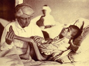 Dr. Mabel Elliott with an emaciated young patient. Many children arrived at the orphanages suffering from severe malnutrition.