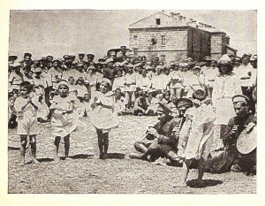 Alice meets happy and healthy children at a Near East Relief orphanage. She also meets children that have been turned away for lack of resources.  Still image from ‘Alice in Hungerland’ showing orphans performing traditional dances for Alice. 