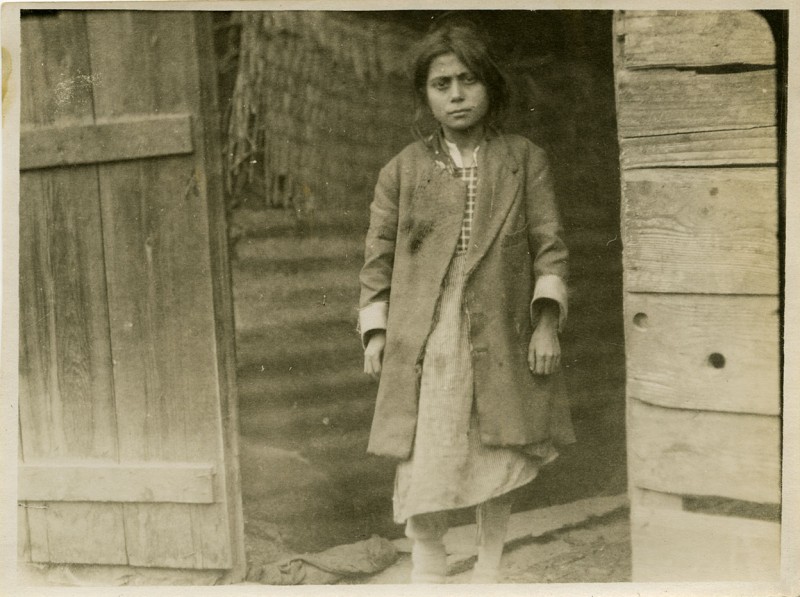 Refugee girl in a doorway