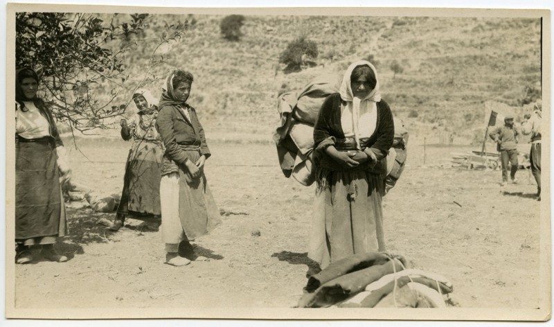 Women refugees carrying bundles on their backs