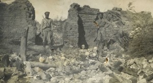 Soldiers (probably Russian) standing over human remains in a burned building. Many Armenians were deported to remote locations and massacred.