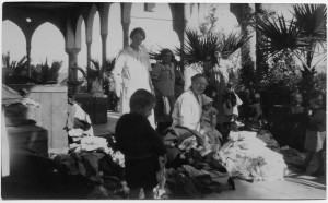 Based on Nellie Miller's notes, Maria Jacobsen (right) is unpacking supplies sent from Denmark. Miss Jacobsen ran the Birds' Nest on behalf of Near East Relief, but she was also a missionary with a Danish organization.