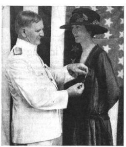 A relief worker receives a medal
