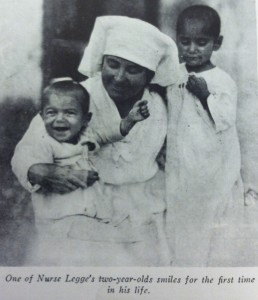 Nurse Gertrude Legge with children. This photograph was used in a letter campaign.