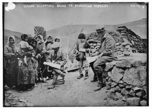 Near East Relief worker Ernest Yarrow distributes supplies to widows and children in the Caucasus, where he was the Director of relief operations.