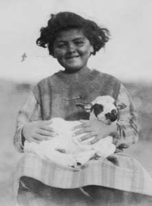 Young girl holding a baby goat