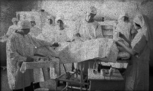 Nurses gather around a patient on table