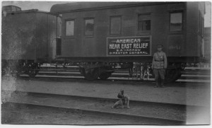 E.A. Yarrow, NER's director in the Caucasus region, with a Near East Relief train car. Yarrow traveled frequently from his office in Tiflis to relief stations throughout the region. He was very fond of his dog, who appears in many pictures.