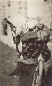 Mother carrying a child in the traditional Armenian manner. Nellie Miller's original caption reads: 