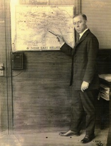 Near East Relief New York State Director Irving Gumb points to a map of Near East Relief activities. 