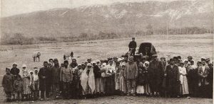 The Assyrian refugees in this picture had recently survived a raid by local Kurds. The raiders took all of the refugees' possessions -- even their clothing. Near East Relief provided the refugees with food and clothing as they tried to return home to Tabriz. This photograph appeared in the May 1922 issue of the New Near East magazine. 