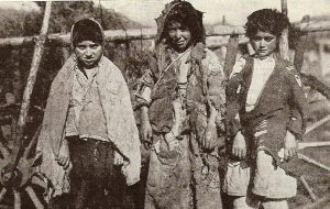 Children dressed in rags waiting outside a Near East Relief Orphanage.